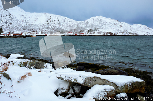 Image of Norwegian fjord with red rorbu houses in Norway in winter