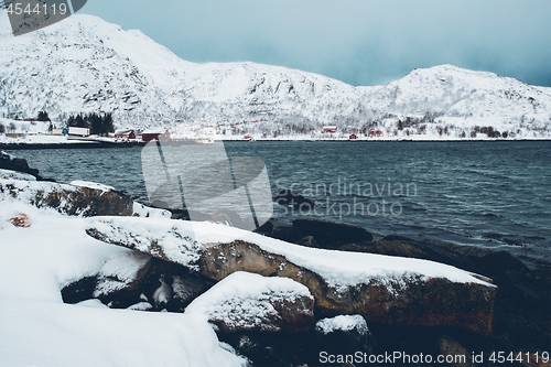 Image of Norwegian fjord with red rorbu houses in Norway in winter