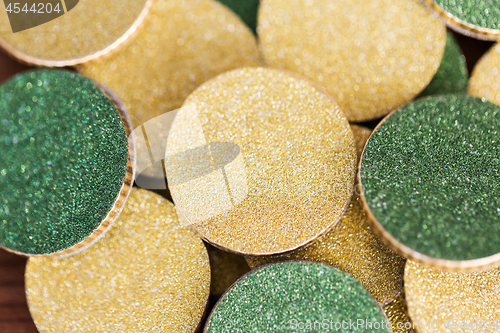 Image of close up of golden and green coins