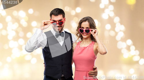 Image of happy couple in heart-shaped sunglasses