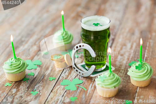 Image of glass of beer, cupcakes, horseshoe and gold coins