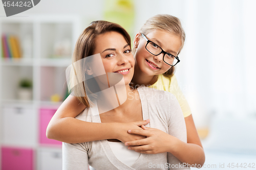 Image of portrait of happy mother and daughter at home