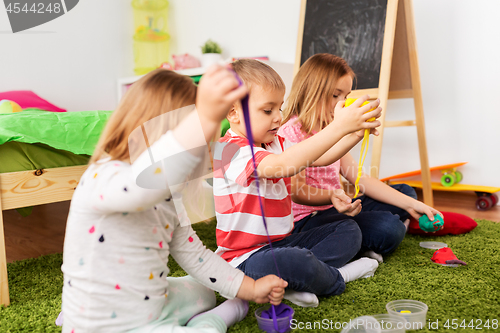 Image of children with modelling clay or slimes at home