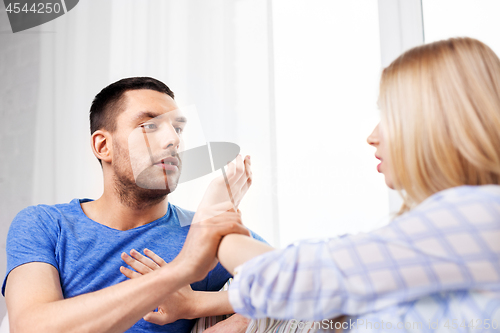 Image of unhappy couple having argument at home