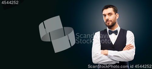 Image of man in shirt and bowtie over black background