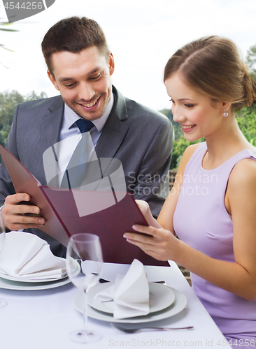 Image of couple with menu at restaurant