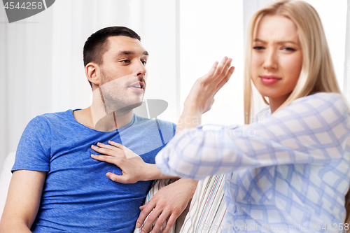 Image of unhappy couple having argument at home