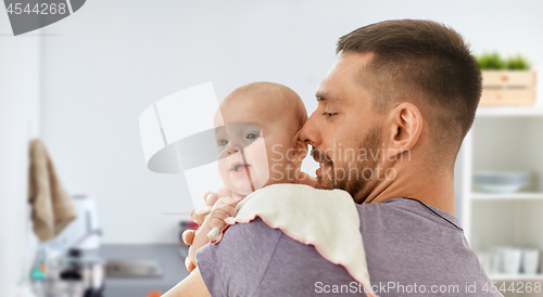 Image of father with baby over kitchen background