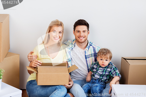 Image of happy family with boxes moving to new home