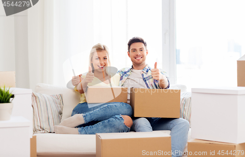 Image of happy couple with boxes moving to new home