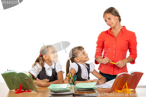 Image of Girls at their desks have fun watching their beloved teacher