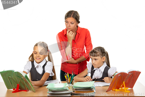 Image of The student asked the teacher a question, the teacher looks at the book in disbelief