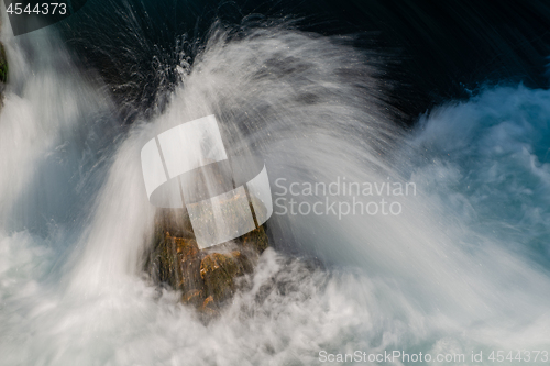 Image of single stone in wild river