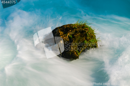 Image of single stone in wild river