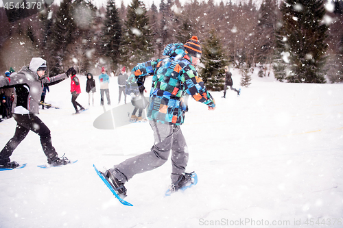 Image of group of young people having a running competition on winter day