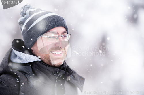 Image of Portrait of young man on snowy winter day