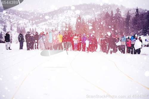 Image of group of young people having a running in bag competition