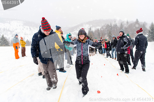 Image of group of young people having blindfolded games competition