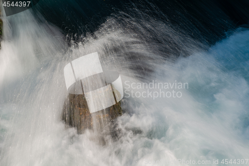 Image of single stone in wild river