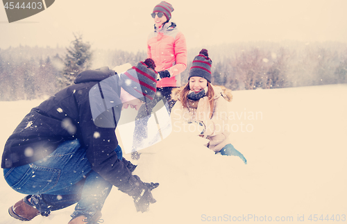 Image of group of young people making a snowman