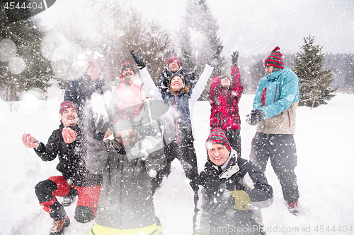 Image of group of young people throwing snow in the air