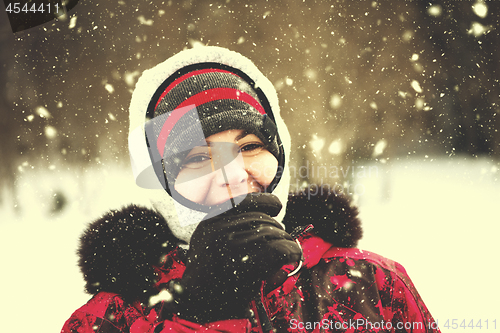 Image of Portrait of young woman on snowy winter day