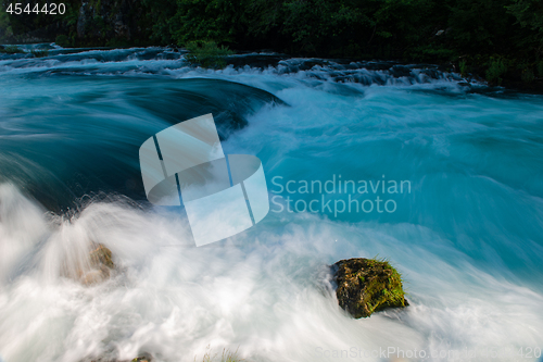 Image of single stone in wild river