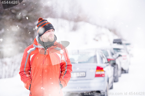 Image of Portrait of young man on snowy winter day