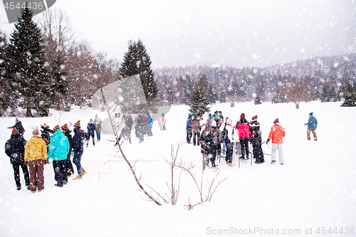 Image of group of young people making a snowman