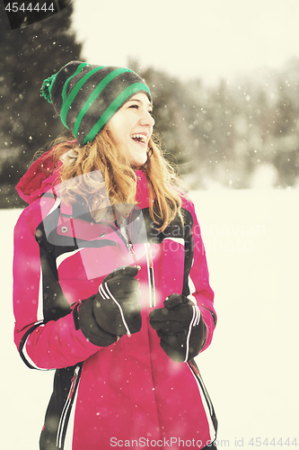 Image of Portrait of young woman on snowy winter day