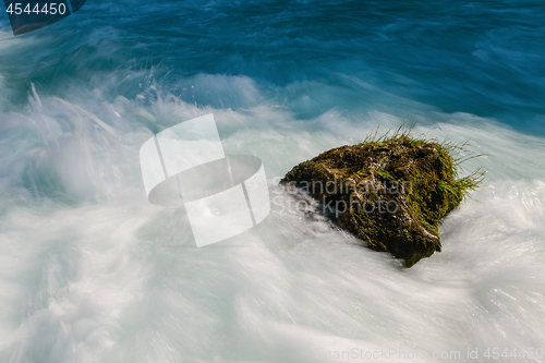 Image of single stone in wild river