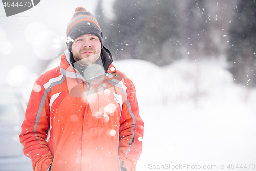 Image of Portrait of young man on snowy winter day