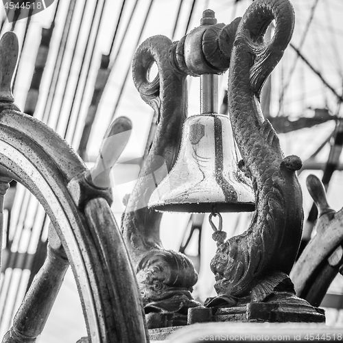 Image of Ship\'s Bell and wheel the old sailboat, close-up 