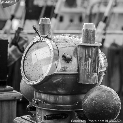 Image of Reflection of a mast in an old ship compass, closeup. Black and white photo