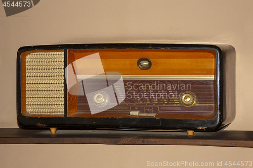 Image of Old vintage radio on the wooden shelf 