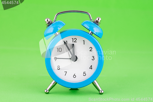 Image of Classic alarm clock on a green background