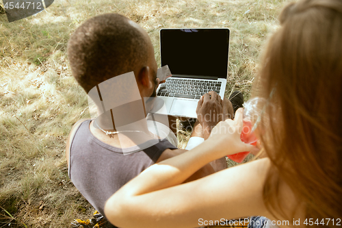 Image of Young multiethnic international couple outdoors