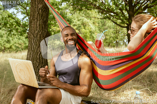 Image of Young multiethnic international couple outdoors