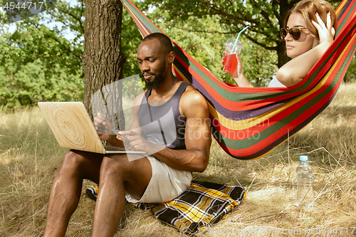 Image of Young multiethnic international couple outdoors