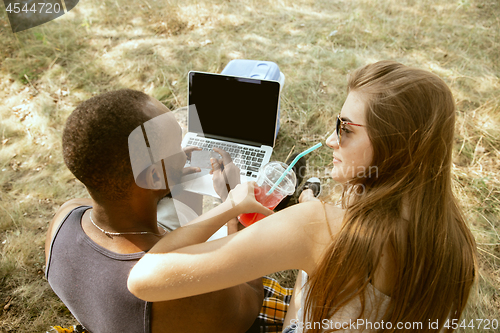 Image of Young multiethnic international couple outdoors