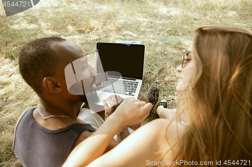 Image of Young multiethnic international couple outdoors