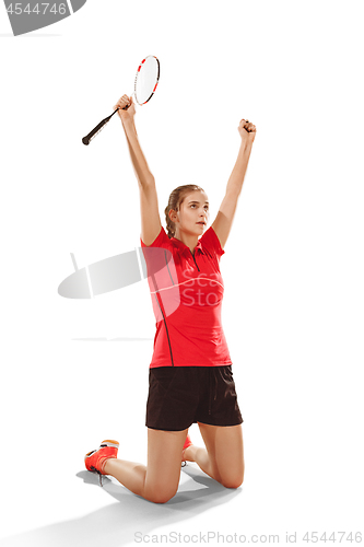 Image of Young woman badminton player as winner posing over white background