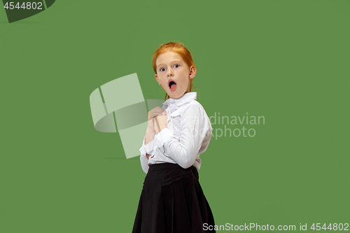 Image of Beautiful teen girl looking suprised isolated on green