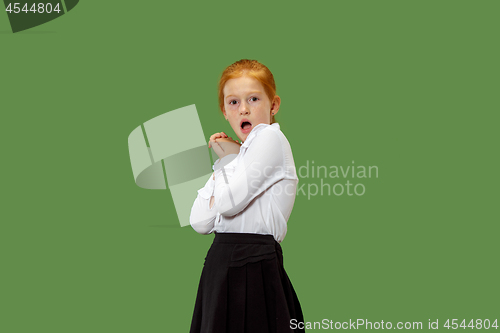 Image of Beautiful teen girl looking suprised isolated on green