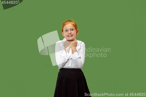 Image of Beautiful teen girl looking suprised isolated on green