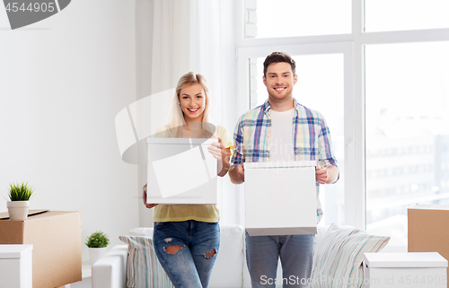 Image of happy couple with boxes moving to new home