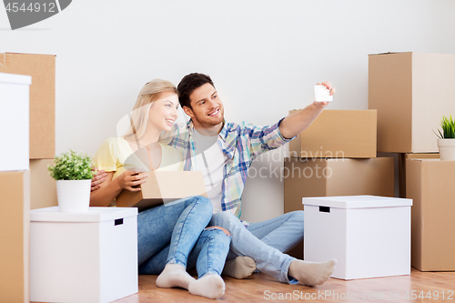 Image of couple taking selfie and moving to new home