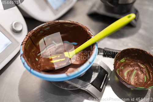 Image of chocolate cream on kitchen scale at confectionery