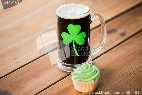 Image of glass of beer with shamrock and green cupcake