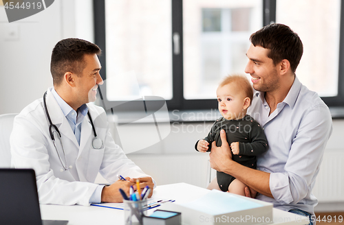 Image of father with baby and doctor at clinic